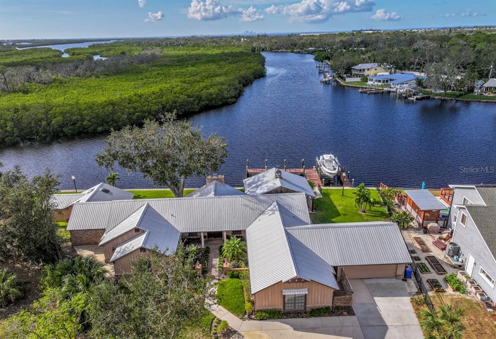 an aerial view of a house with outdoor space and lake view