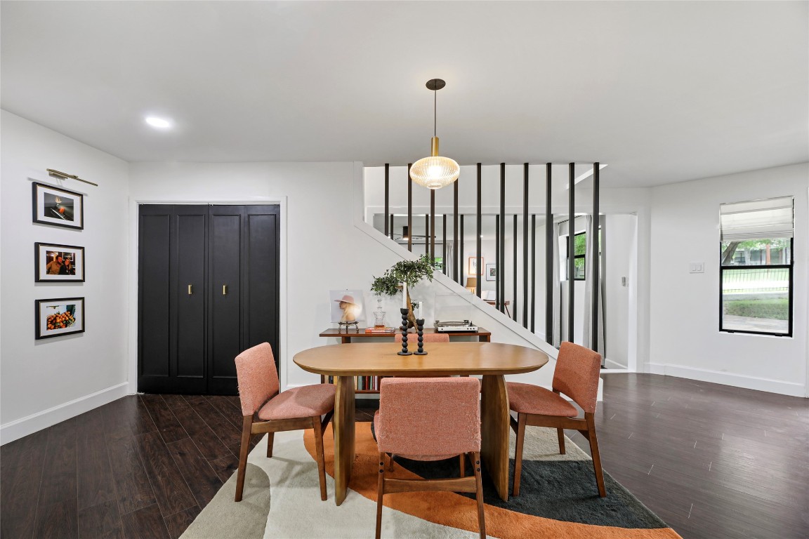 a dining room with furniture a chandelier and wooden floor