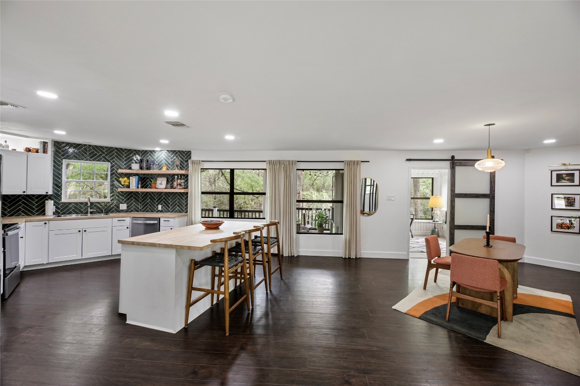 a open kitchen with stainless steel appliances granite countertop a stove and a refrigerator