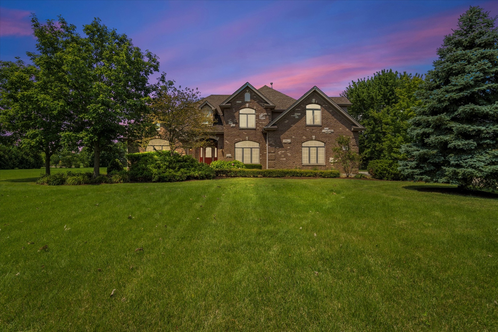 a front view of a house with a yard