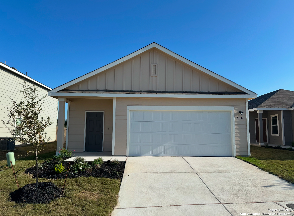 a view of backyard of house and garage