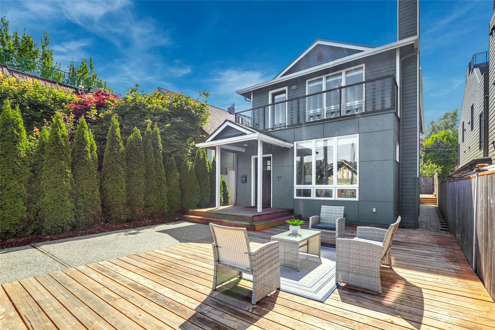 a view of a patio with couches table and chairs and potted plants