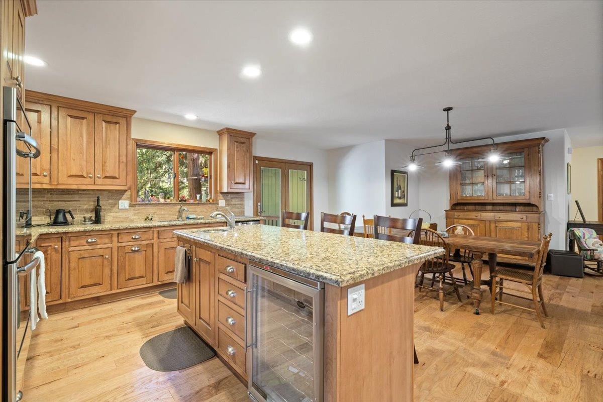 a kitchen with a stove a sink a dining table and chairs