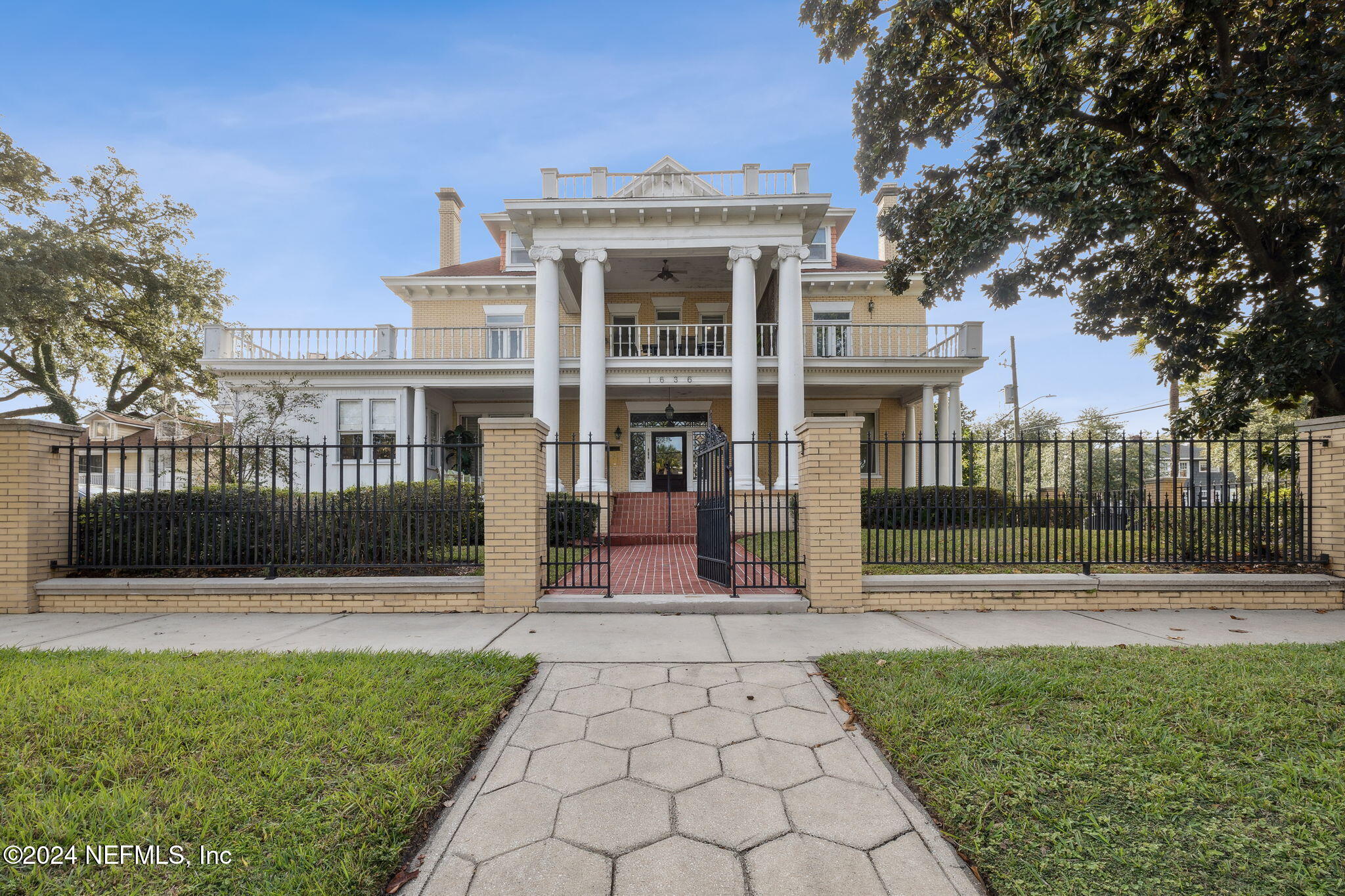 a front view of a house with a garden