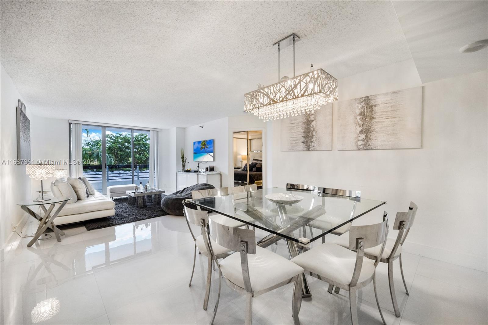 a view of a dining room with furniture wooden floor and chandelier