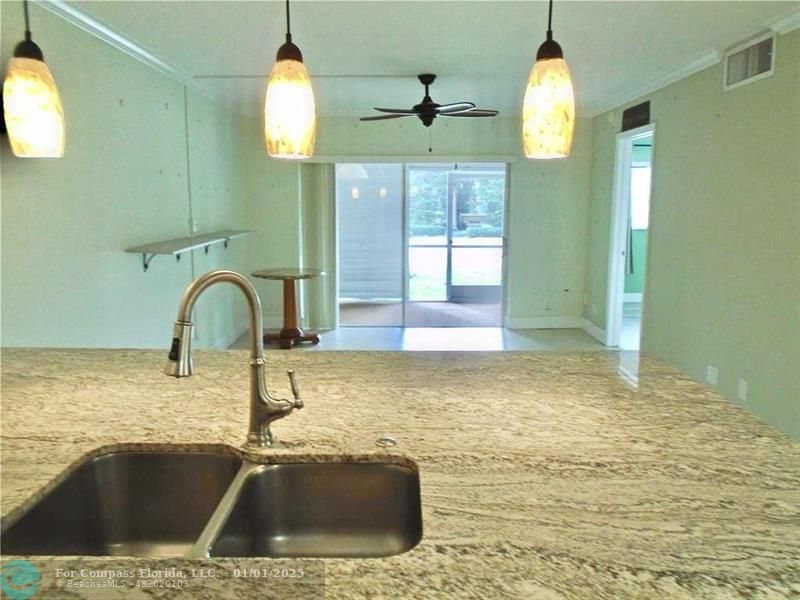 a view of a kitchen counter top a sink and dishwasher