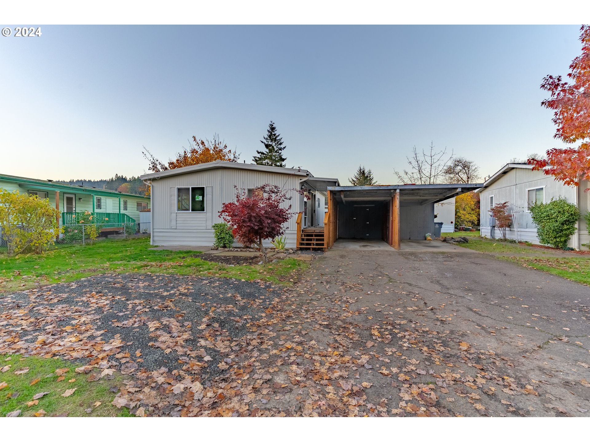 a view of a house with a yard and a garage