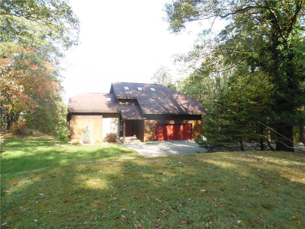 a view of house with outdoor space and garden