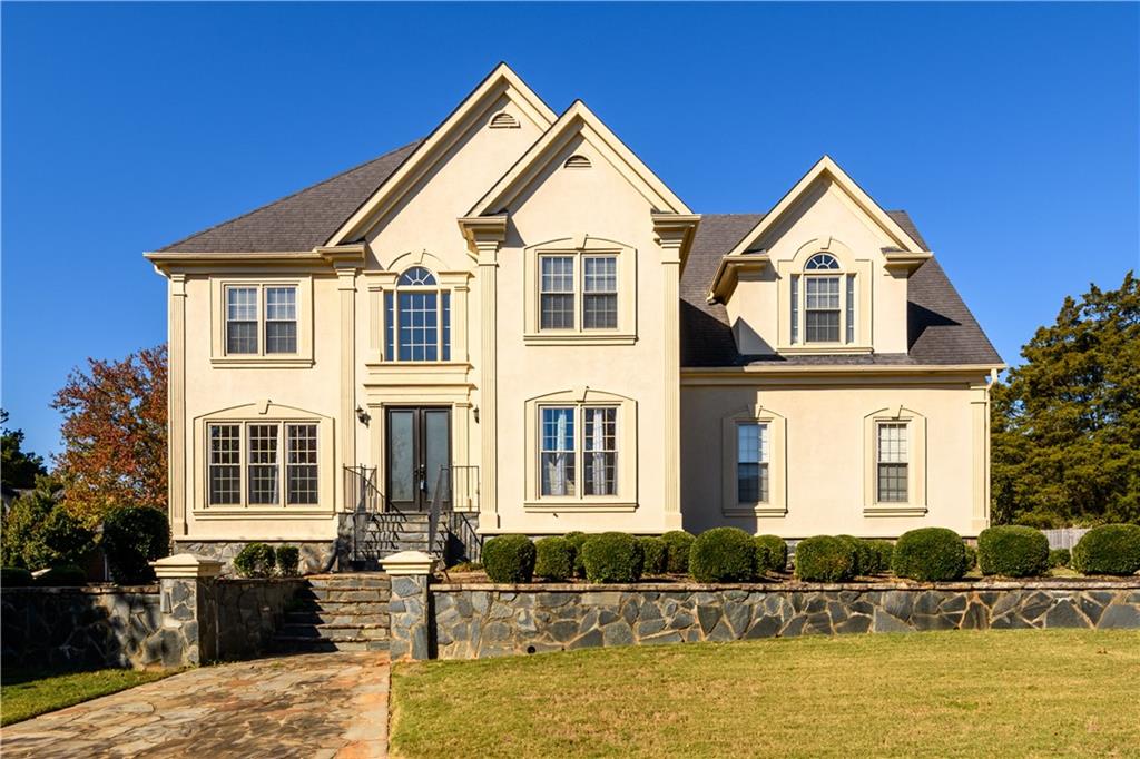 a front view of a house with a yard