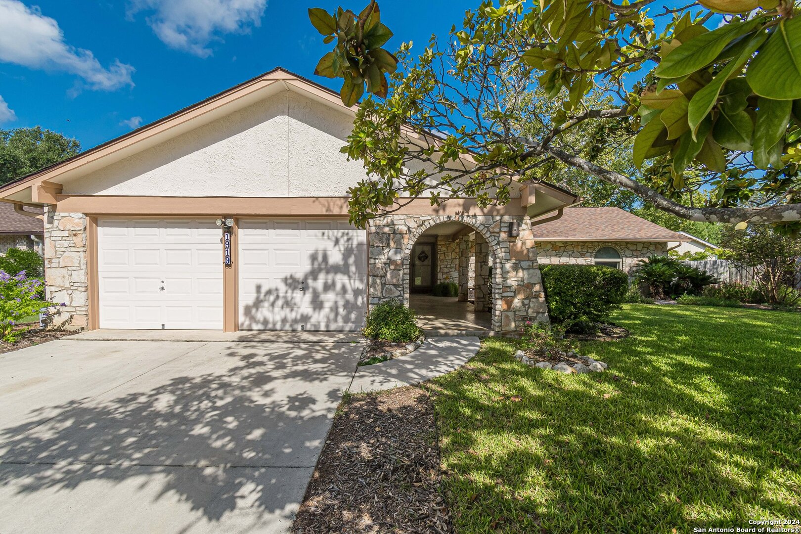 a front view of a house with a yard and garage