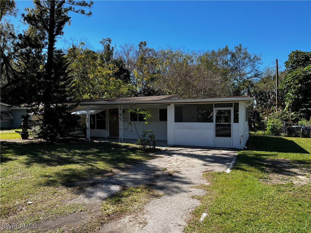 a view of a house with a yard in the background