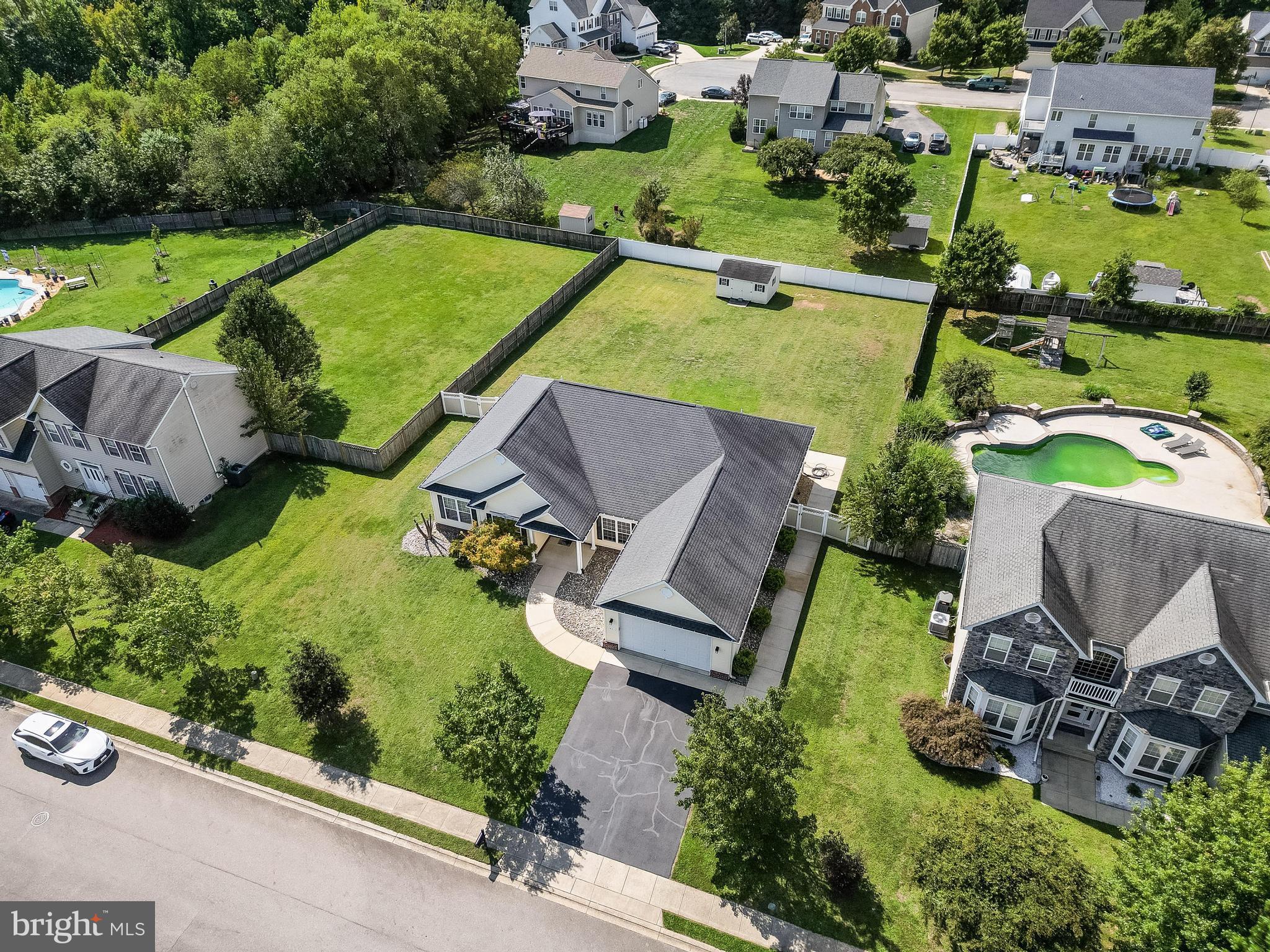 an aerial view of a house with garden space and street view