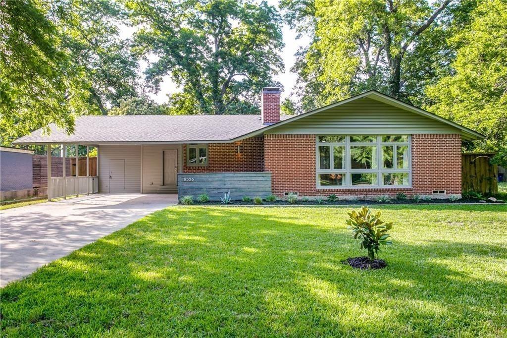 a house that has a big yard with large trees