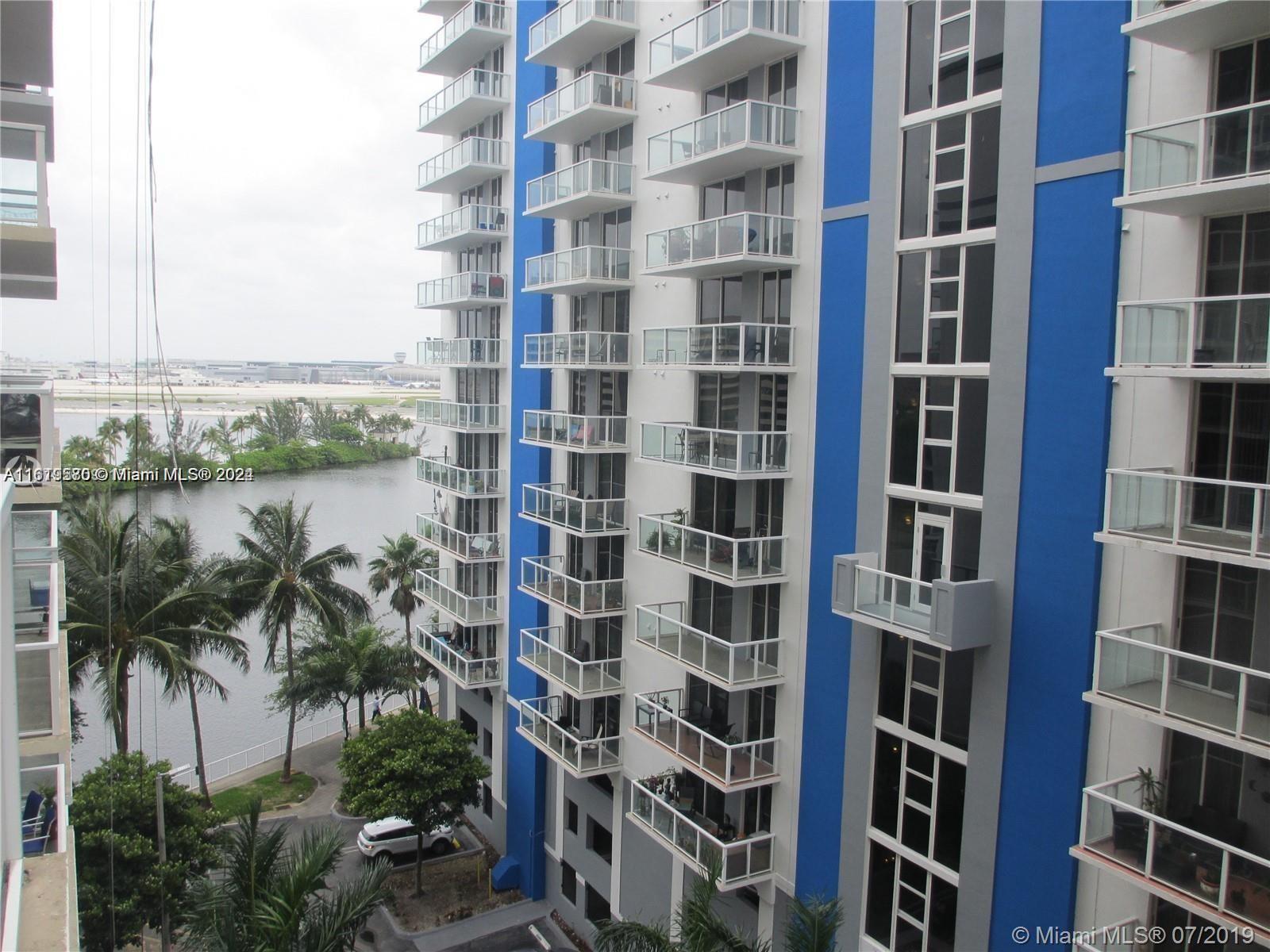 a view of a tall building next to a yard