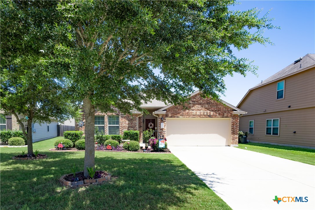 a front view of a house with a yard and fountain