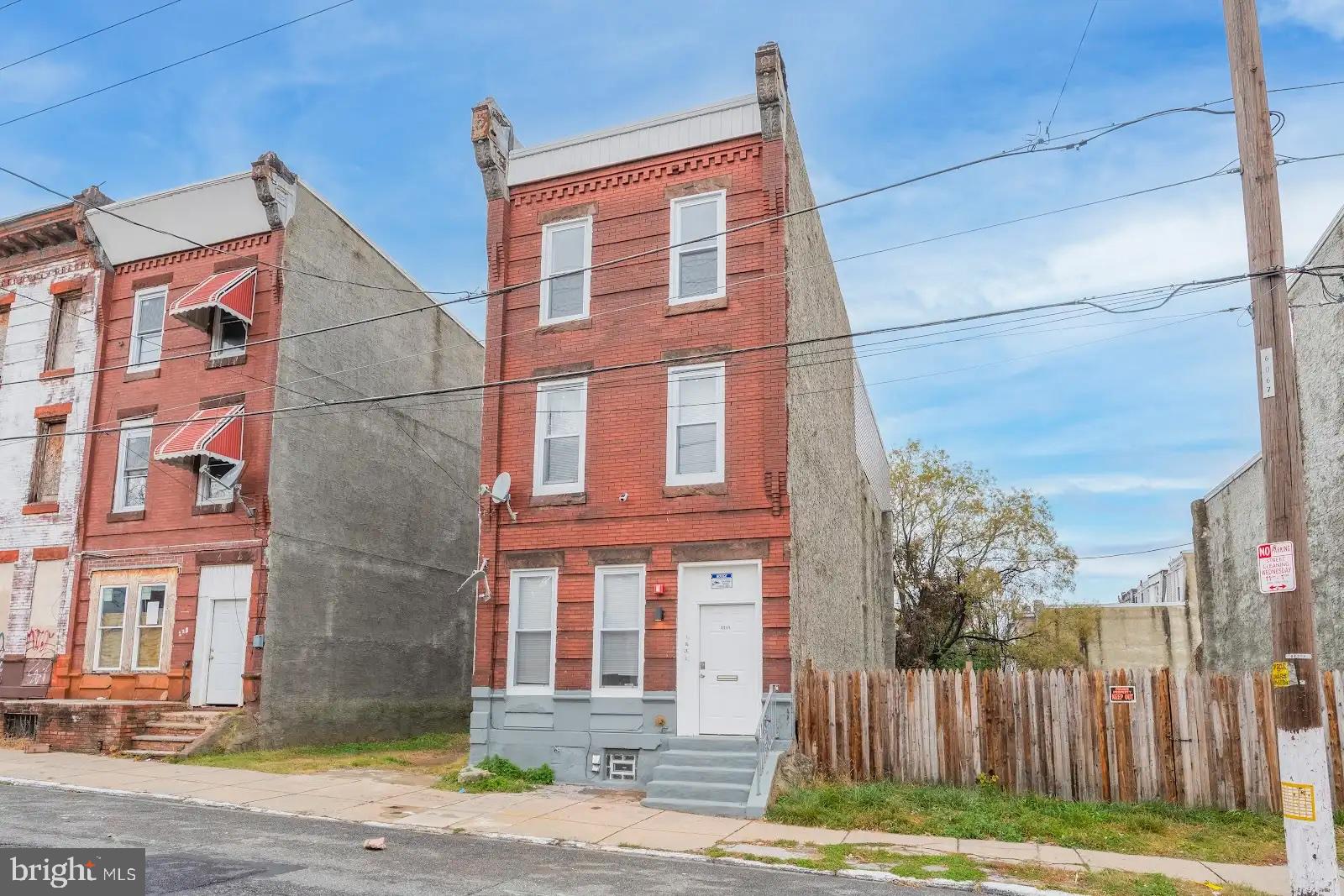 a view of a brick building next to a yard