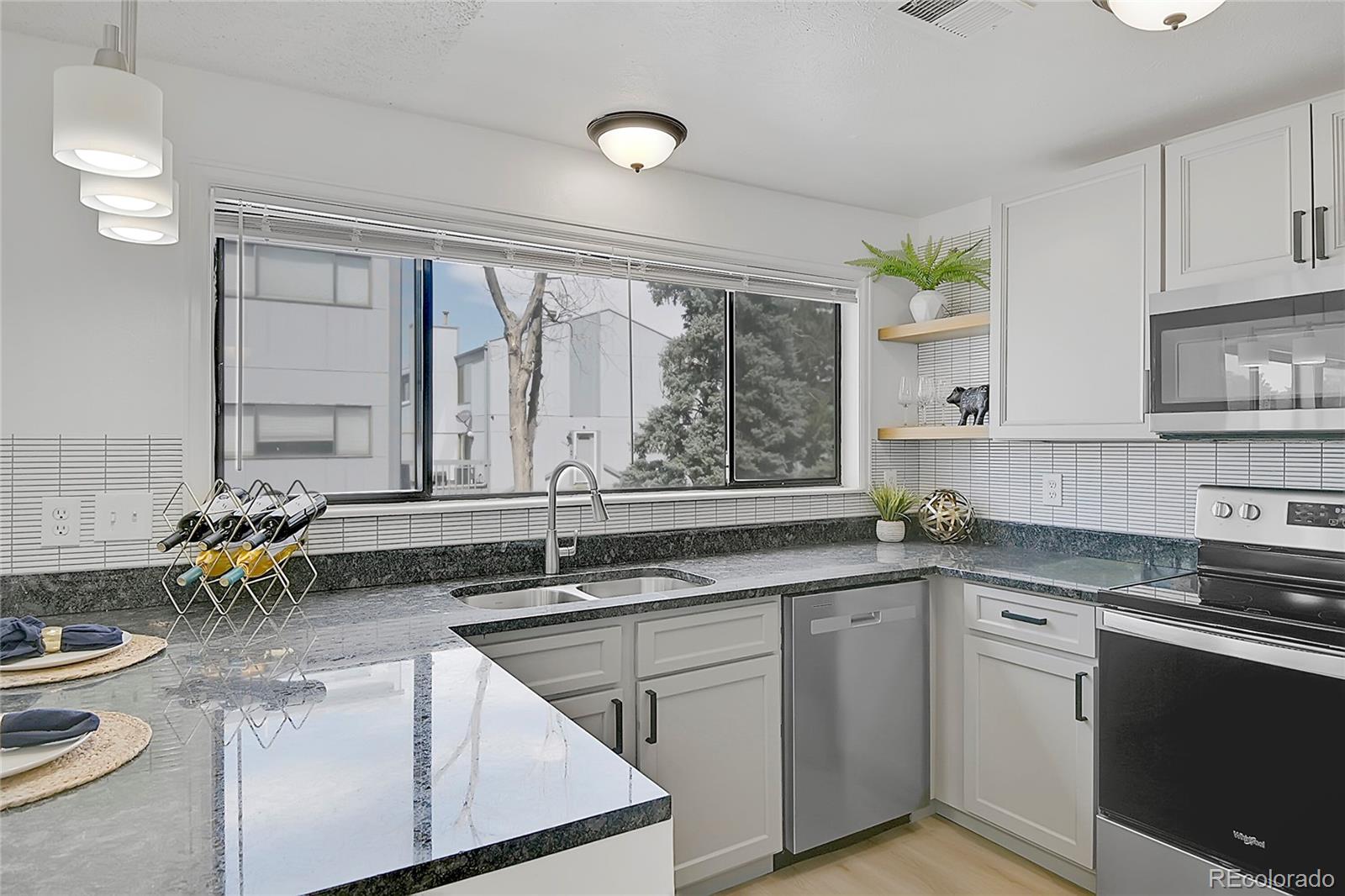 a kitchen with a sink stove and cabinets