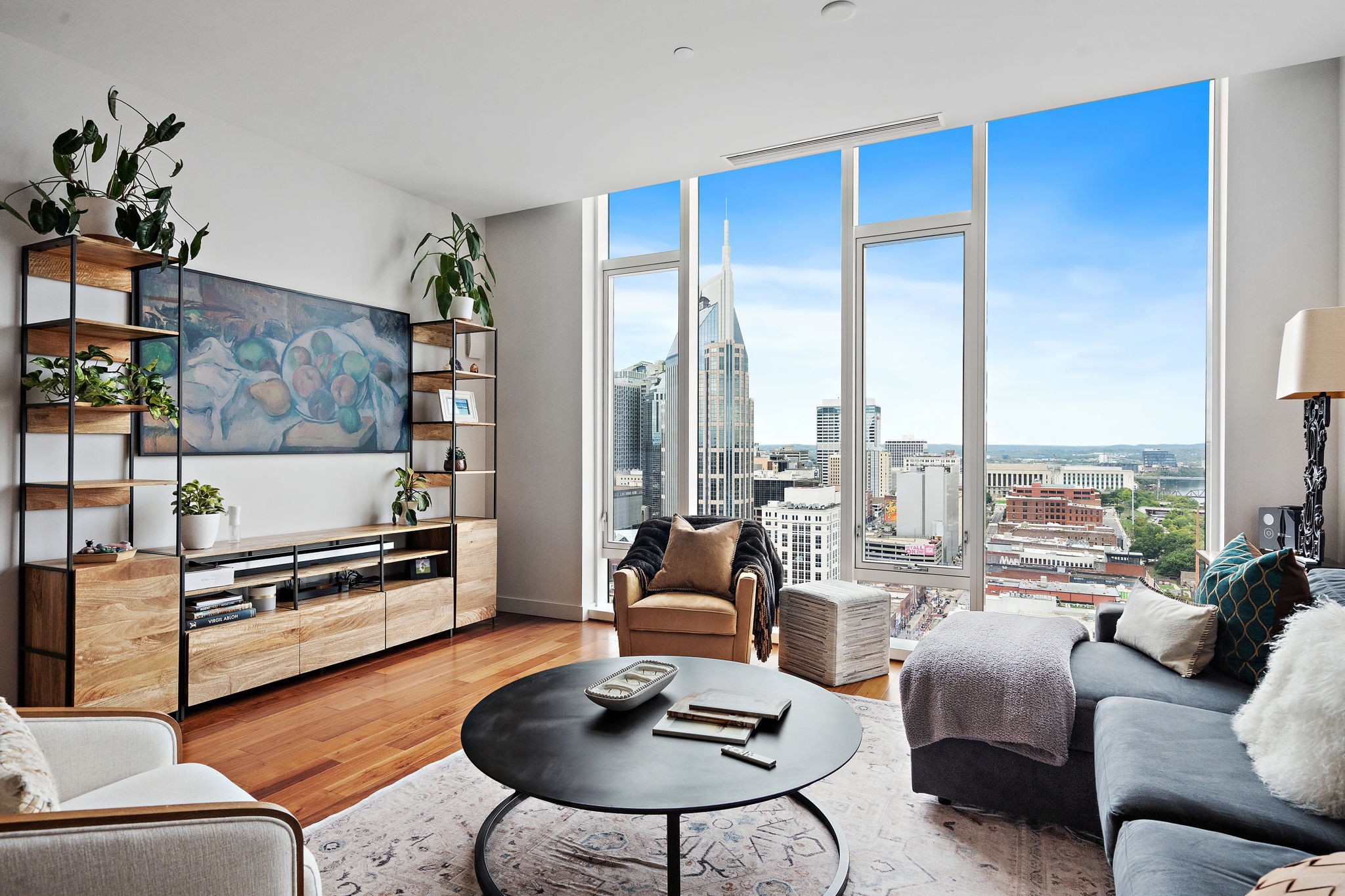 a living room with furniture windows and a table