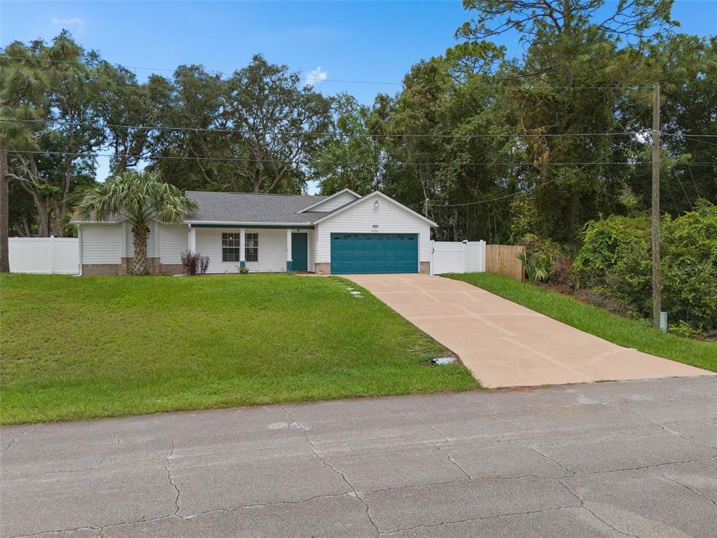 a house with green field in front of it