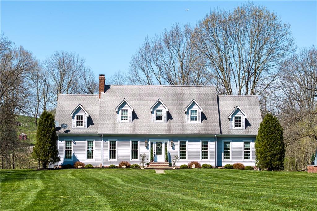 a front view of house with yard and green space