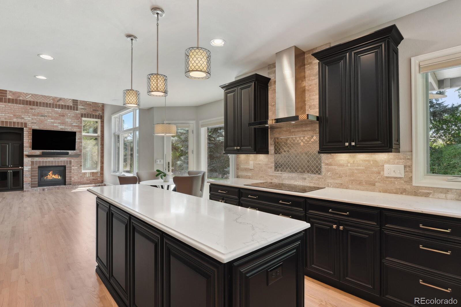 a kitchen with granite countertop a sink a counter space appliances and cabinets