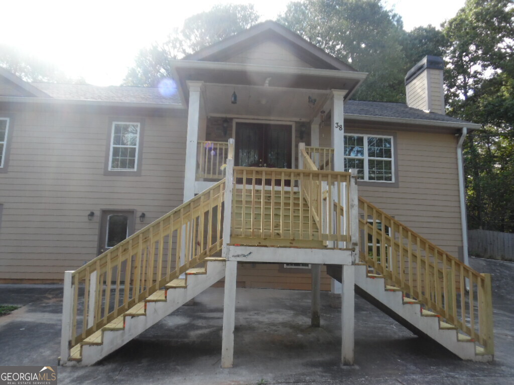 a view of two chair and table in the balcony