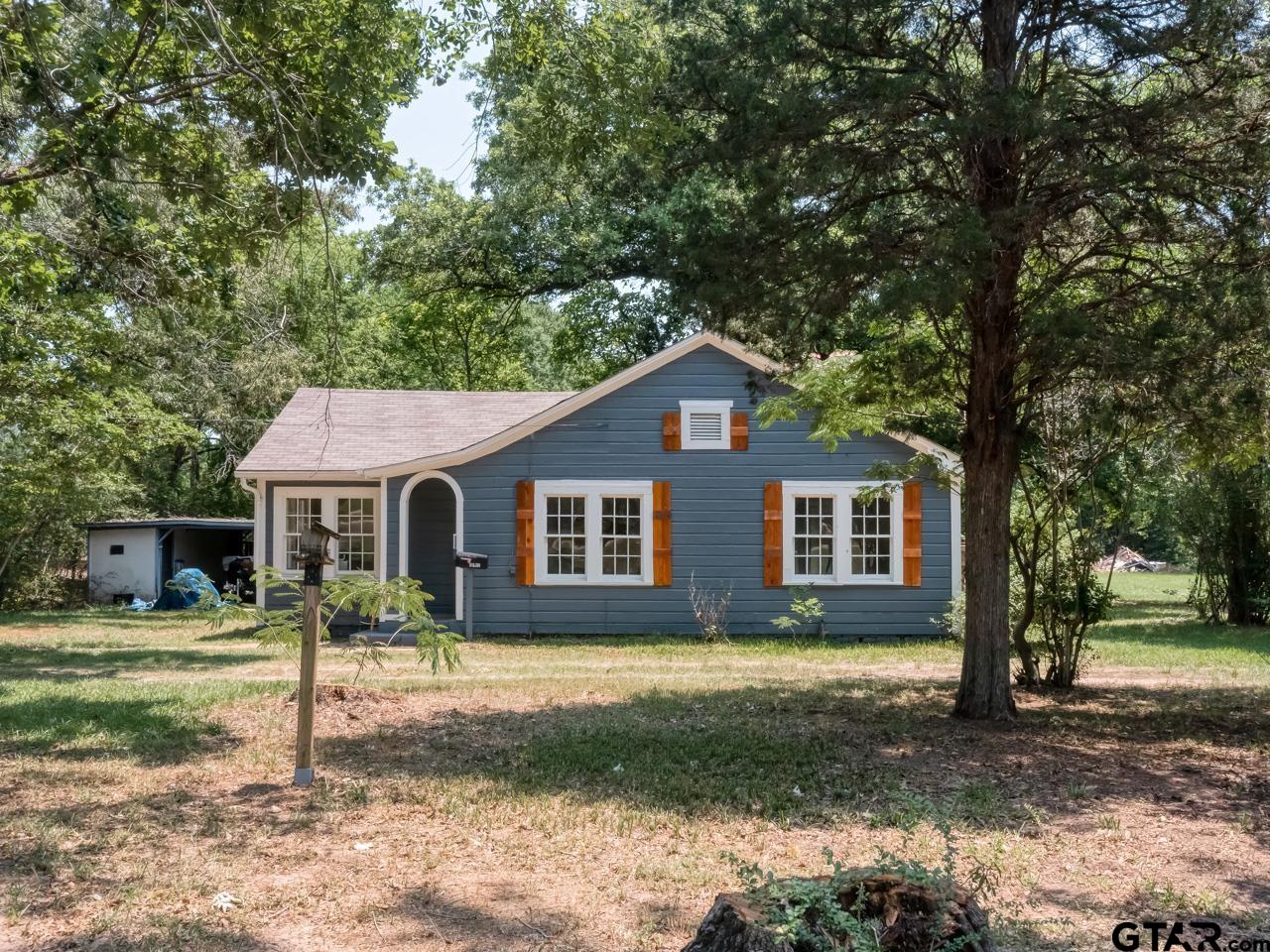 a house that has tree in front of it