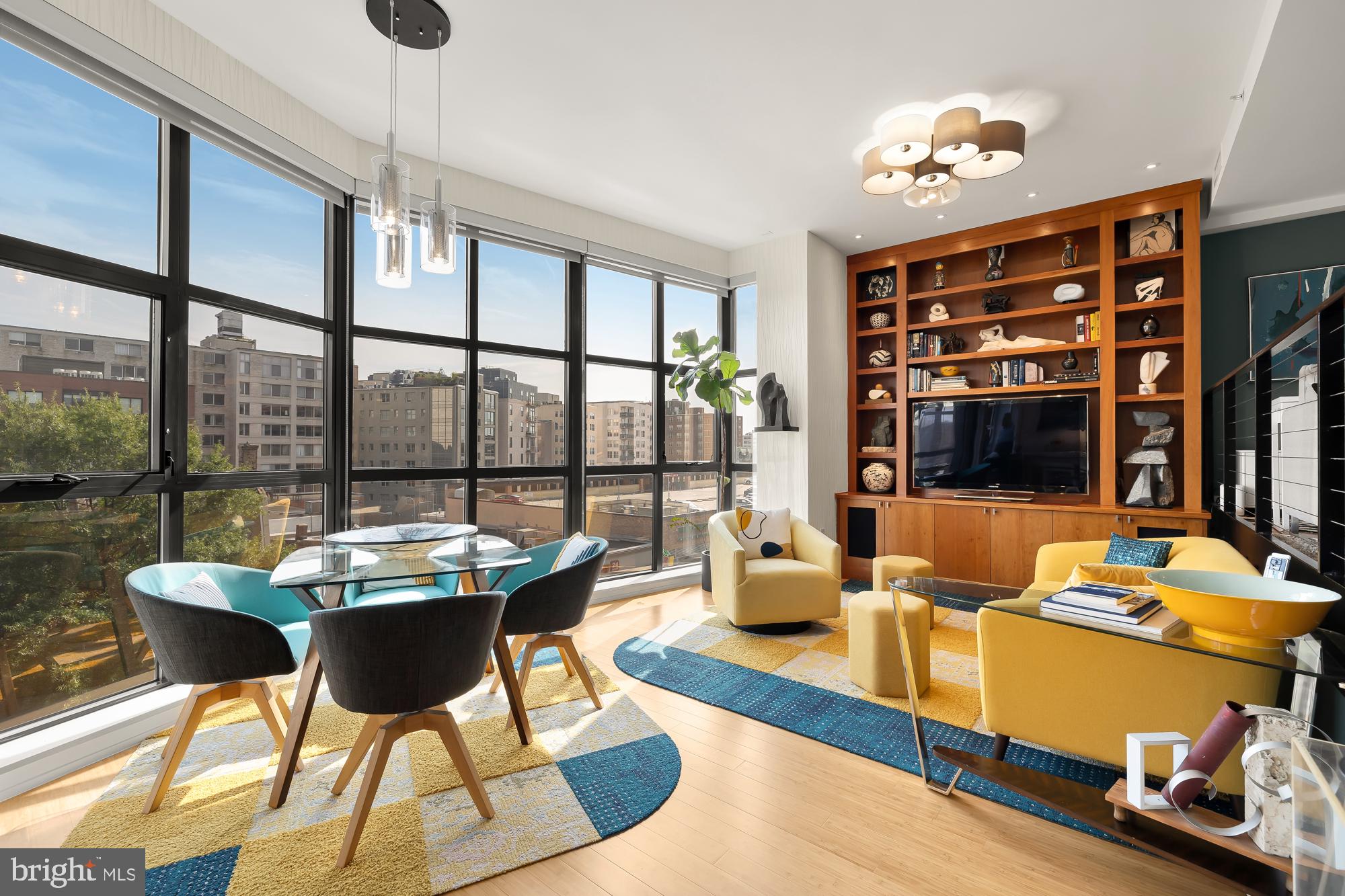 a living room with furniture and a floor to ceiling window