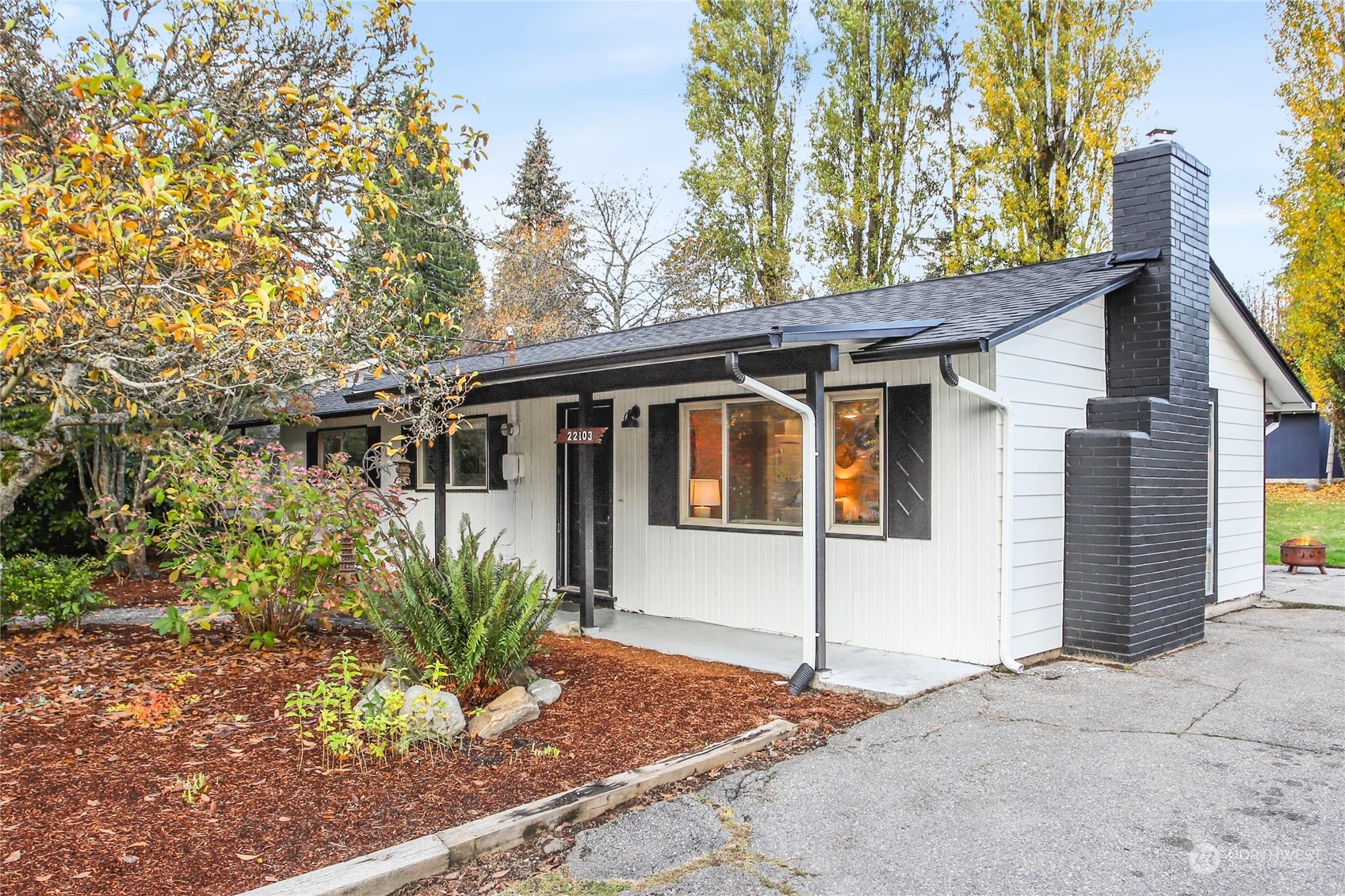 a front view of a house with a garden