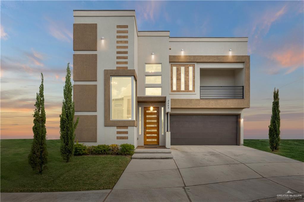 a front view of a house with a yard and garage