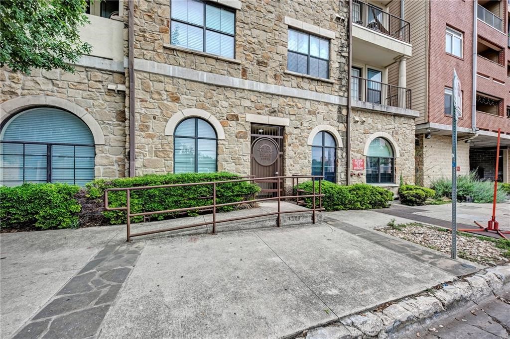 a view of a brick building with a bench in front of it