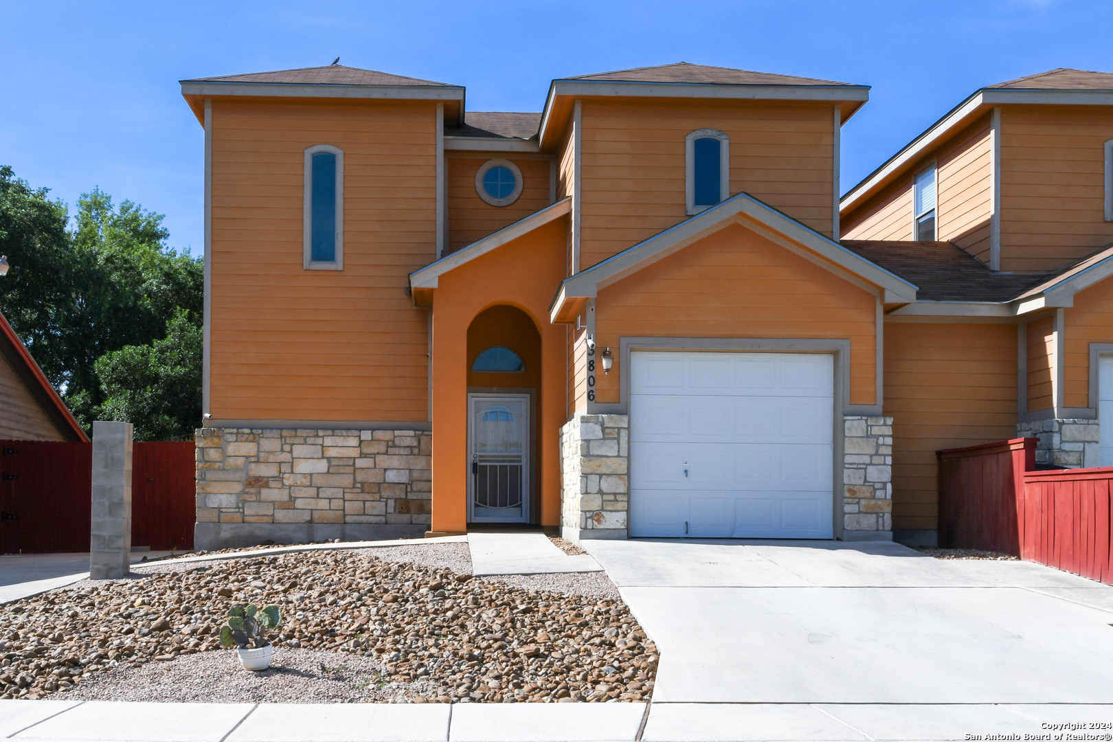 a view of a house with a yard and garage