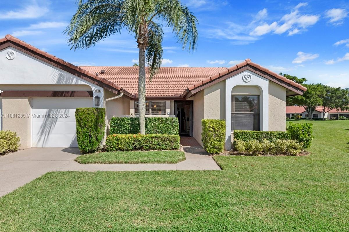 a front view of a house with a yard