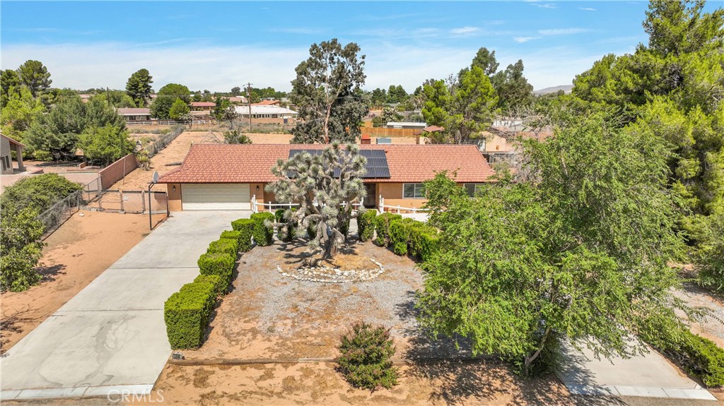 an aerial view of a house with garden space and street view