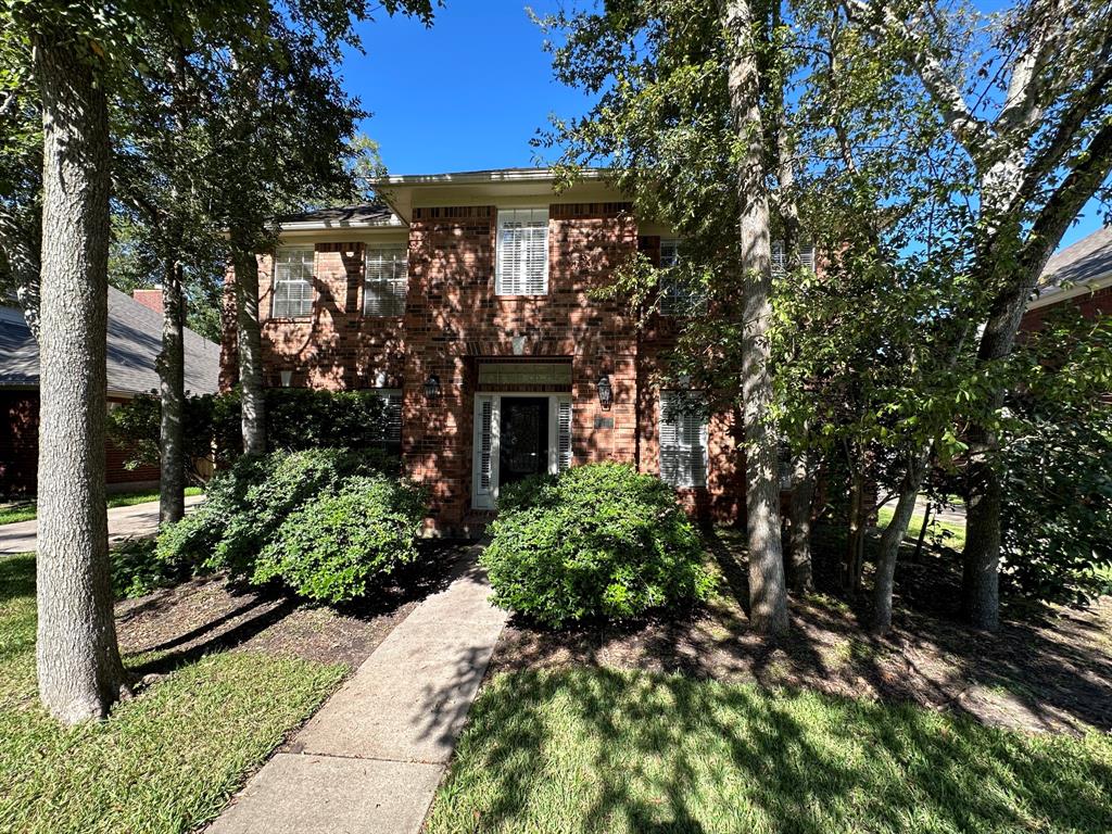 a front view of house with a garden