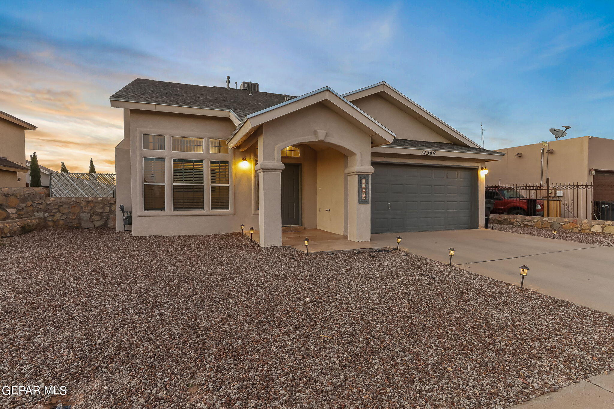 a view of a house with a yard and garage