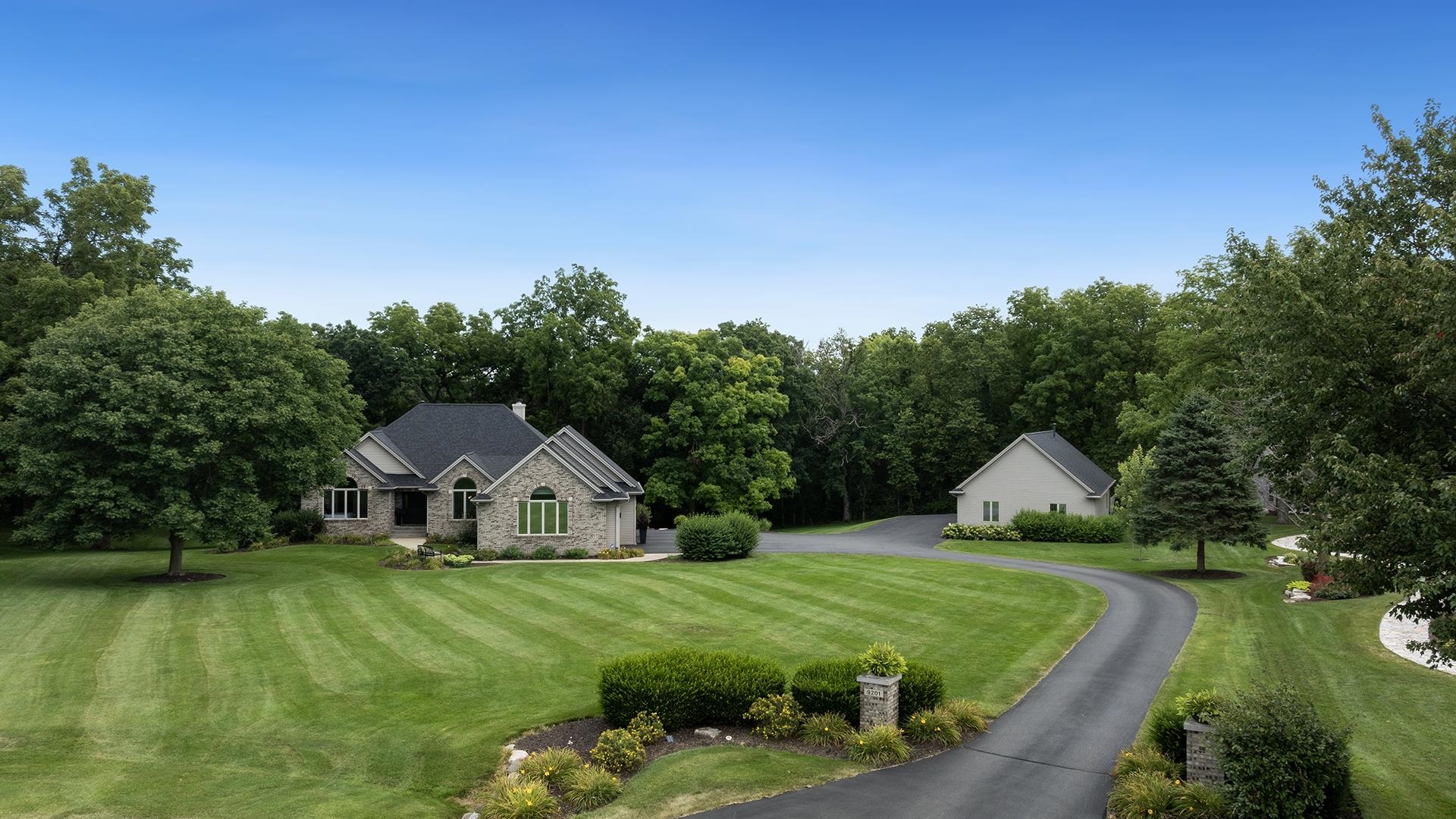 a house with green field in front of it