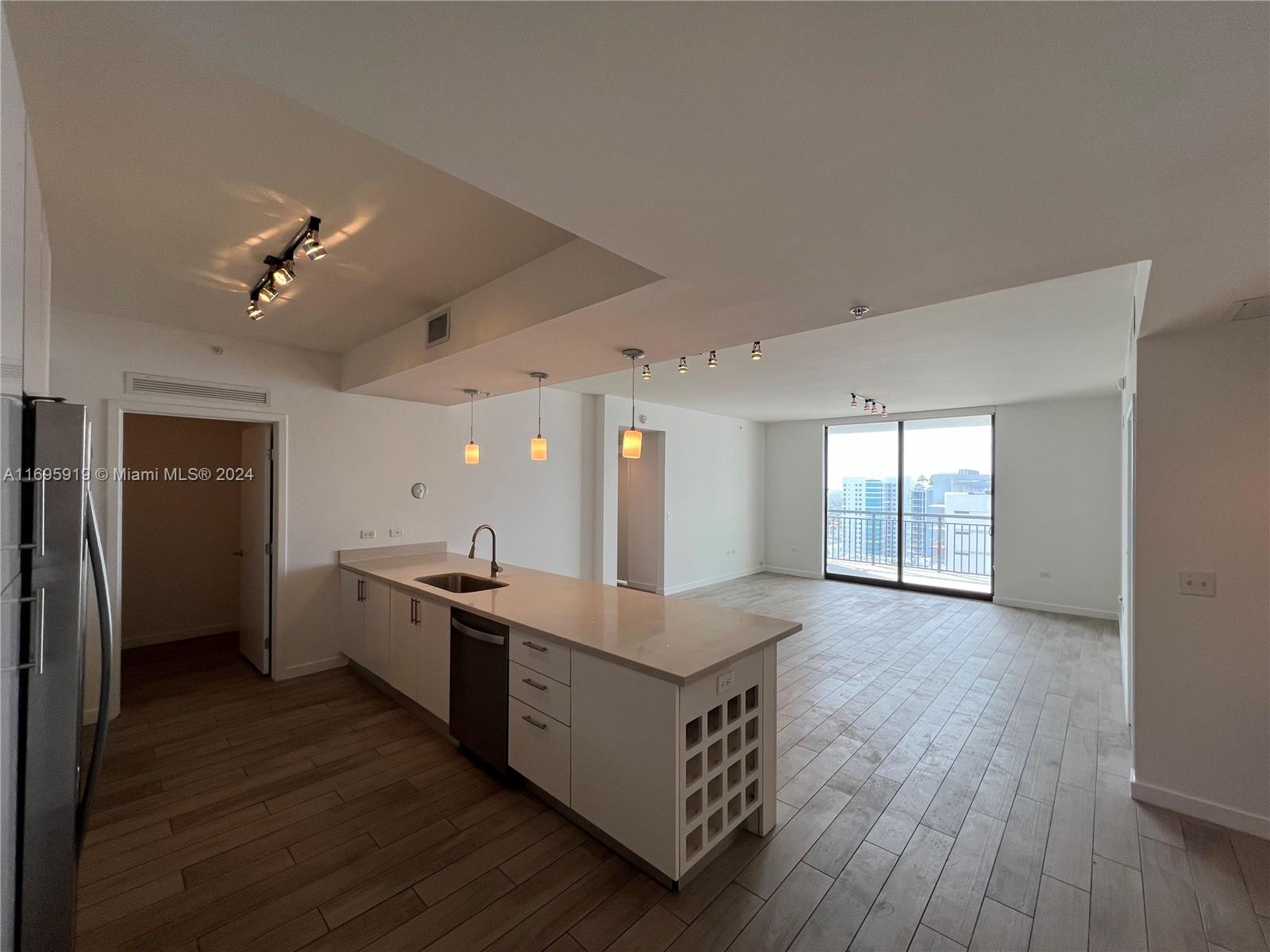 a kitchen with stainless steel appliances granite countertop a sink and a stove