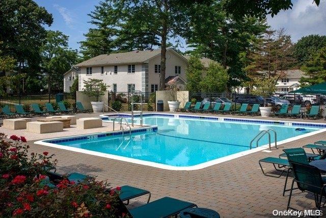 a view of a house with swimming pool and sitting area