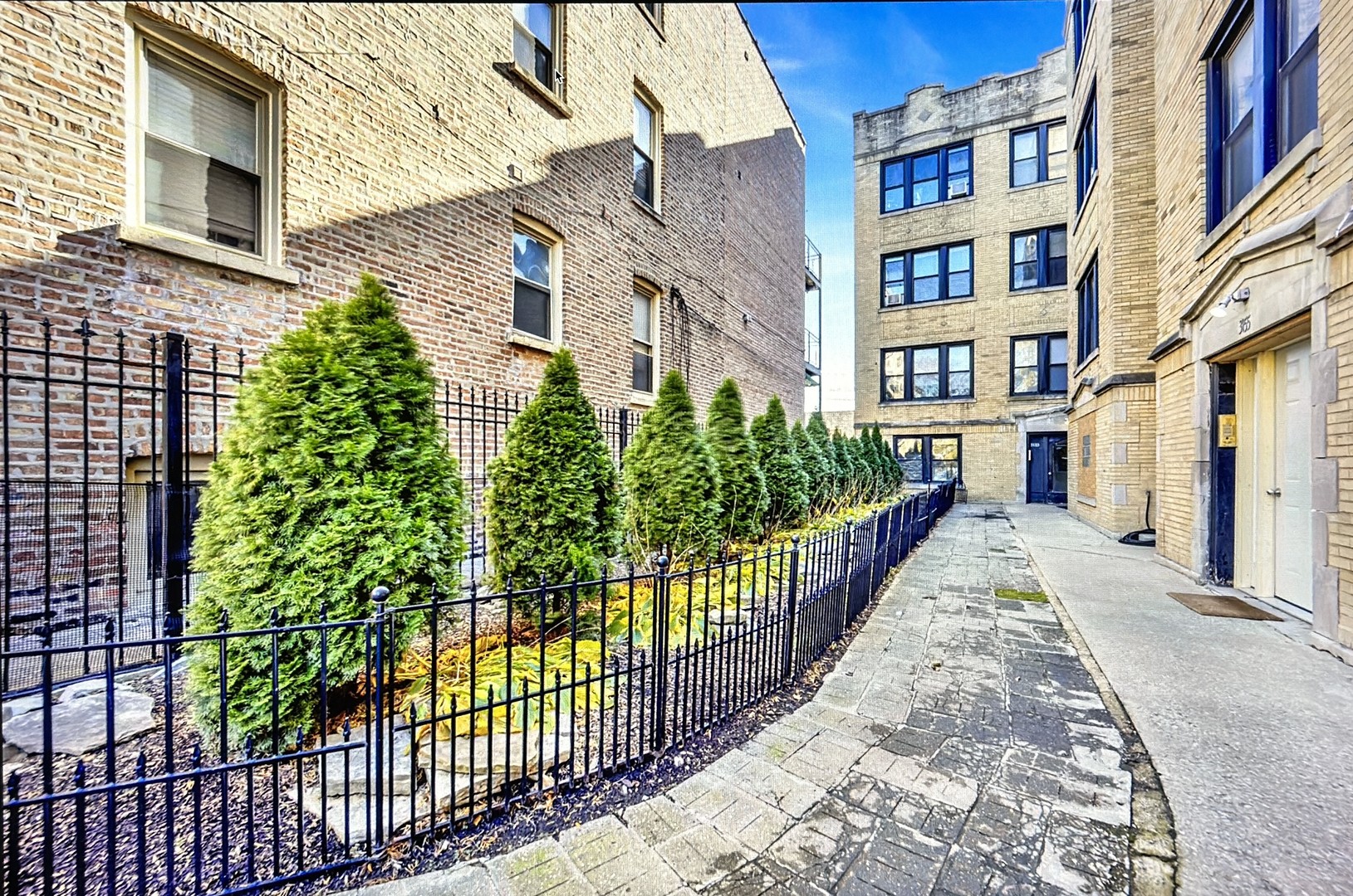 a view of a brick building next to a yard