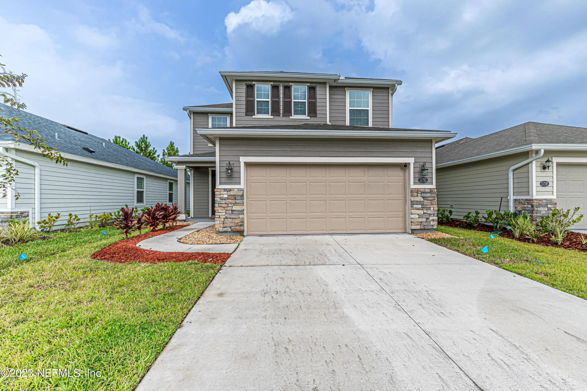 a front view of house with yard and green space