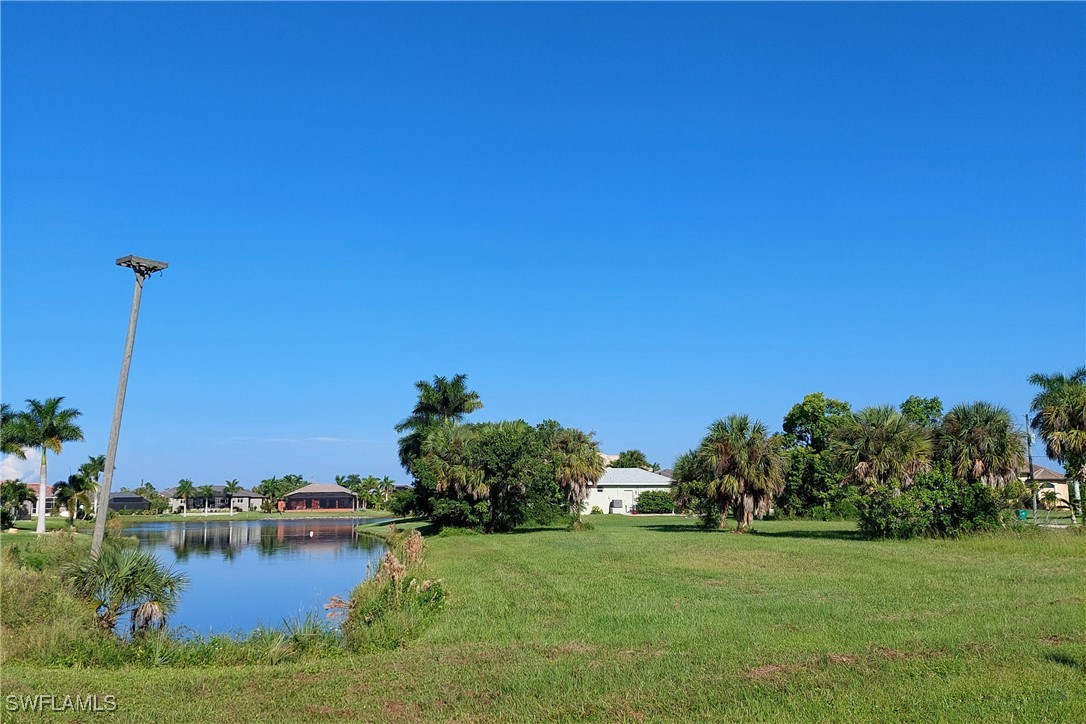 a view of a lake with houses in the background