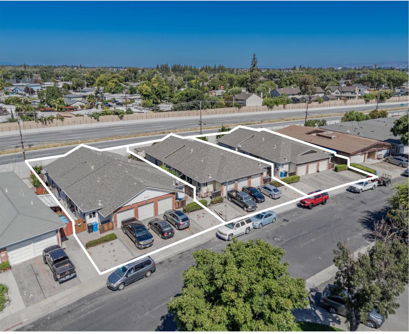 an aerial view of residential houses with outdoor space