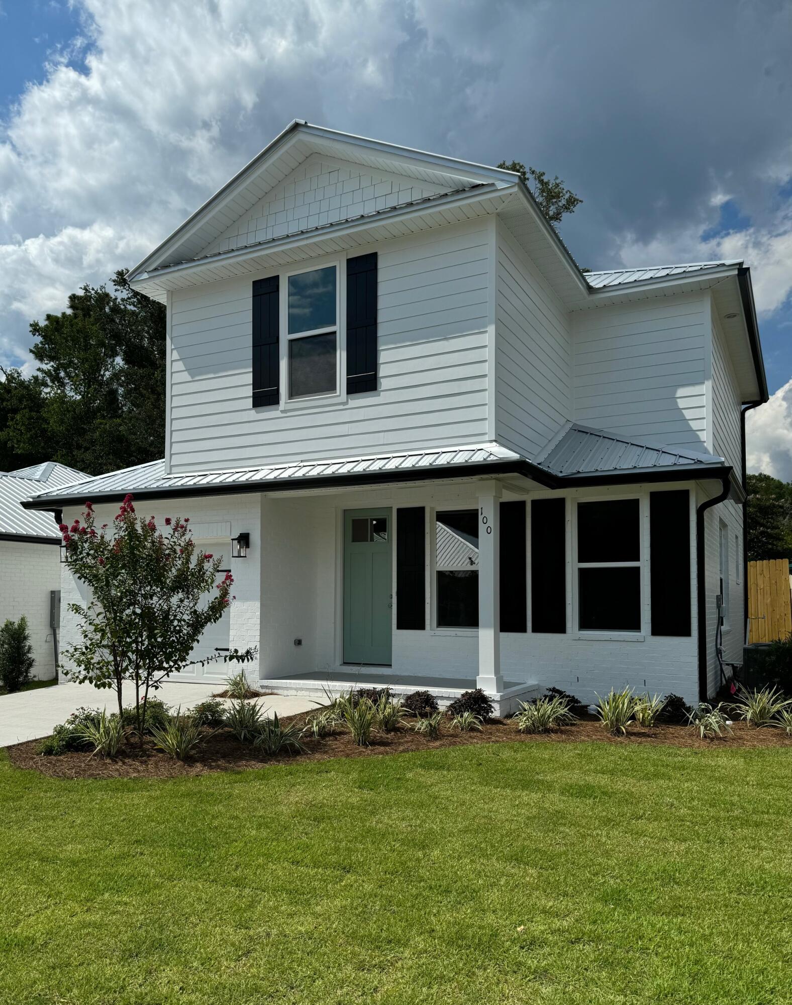 a front view of a house with a garden