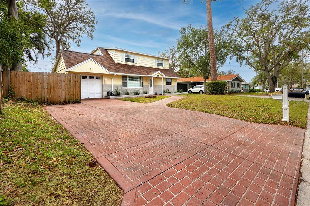 a front view of a house with a yard and trees