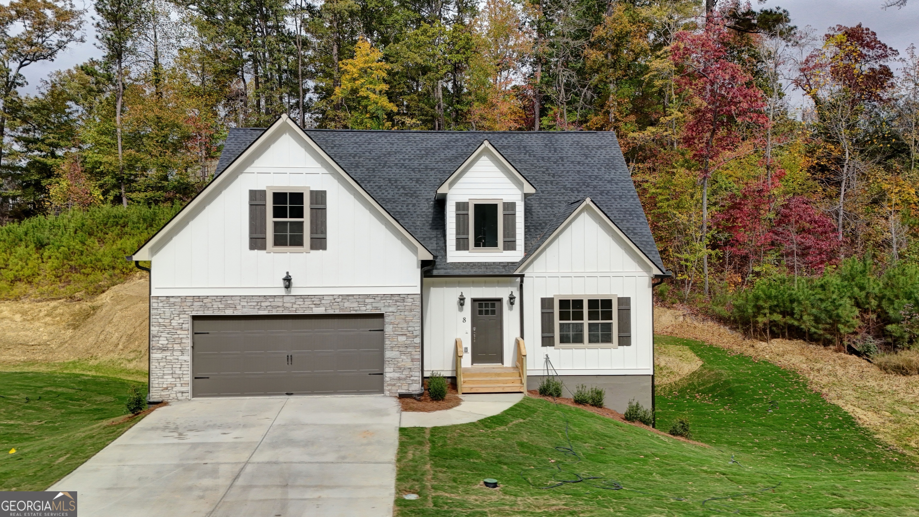 a front view of a house with a yard and garage