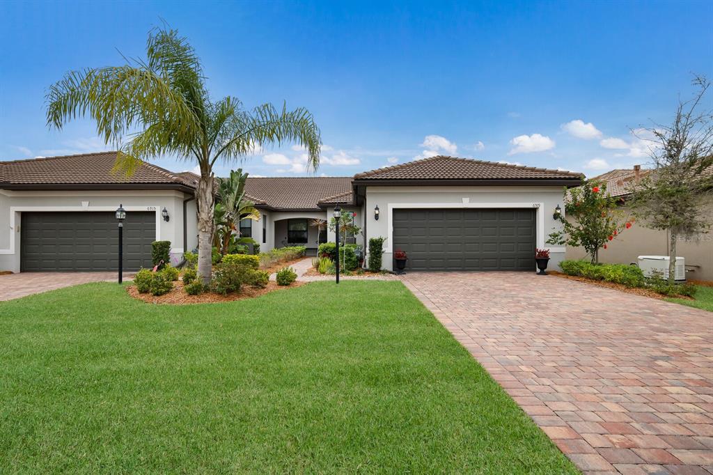 a front view of a house with a yard and garage