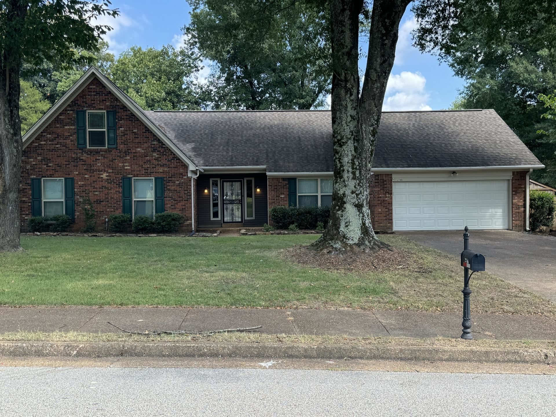 View of front of house featuring a front yard and a garage