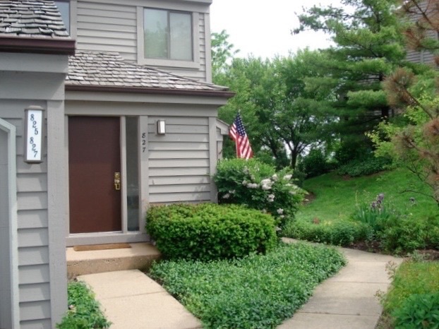 a front view of a house with garden