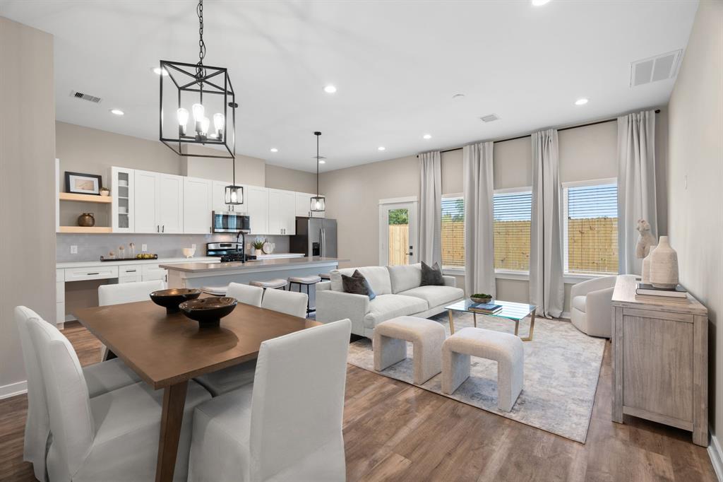 a large kitchen with a large window and stainless steel appliances